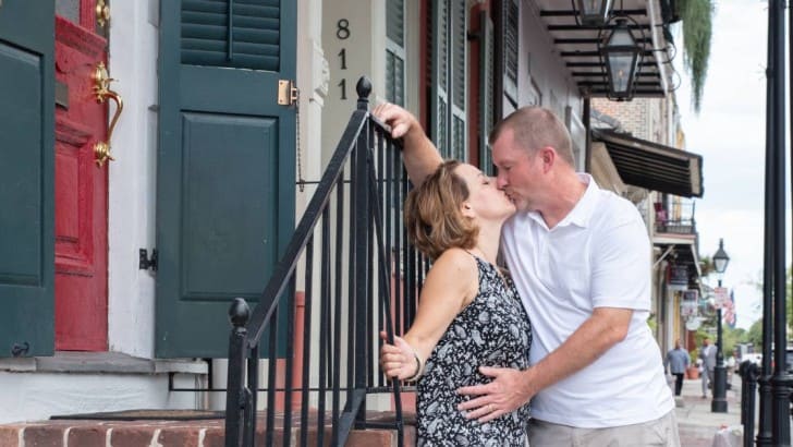 Anne from Simply2Moms kissing her husband in New Orleans.