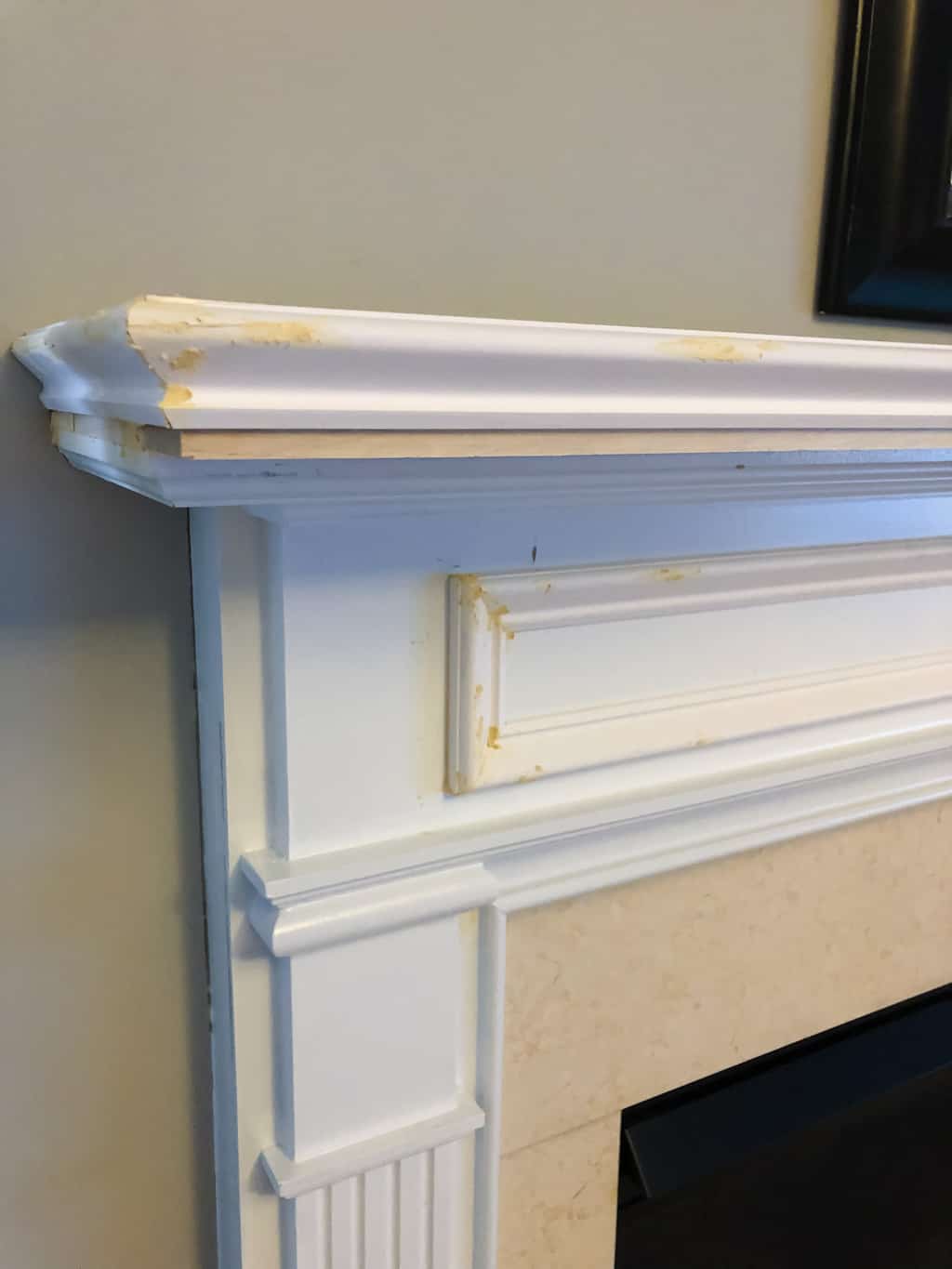 How to make over a builder'grade fireplace with an upgraded mantel by www.simply2moms.com | #fireplacemantel #updatedmantel #fireplacemakeover #mantelupgrade