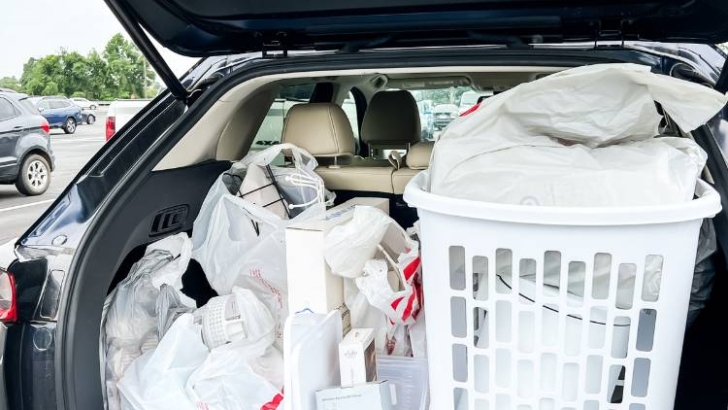 open back of car with bags baskets and products for college