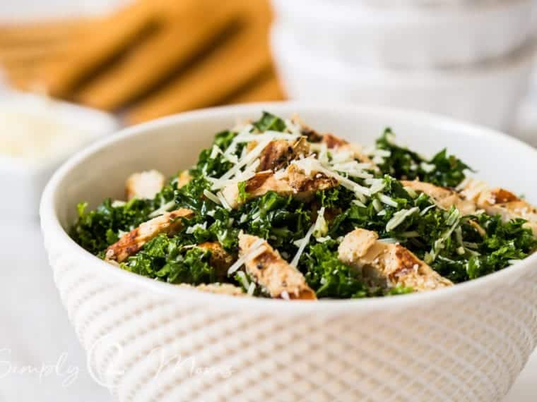 bowl of grilled chicken kale salad sprinkled with parmesan cheese