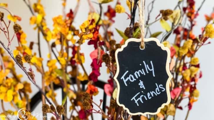 faux fall stems with chalkboard tag hanging from it