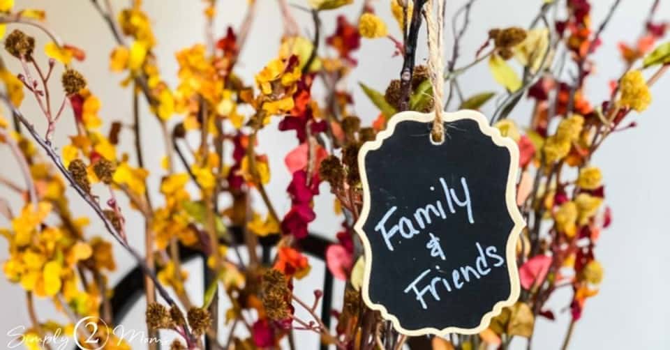 faux fall stems with chalkboard tag hanging from it