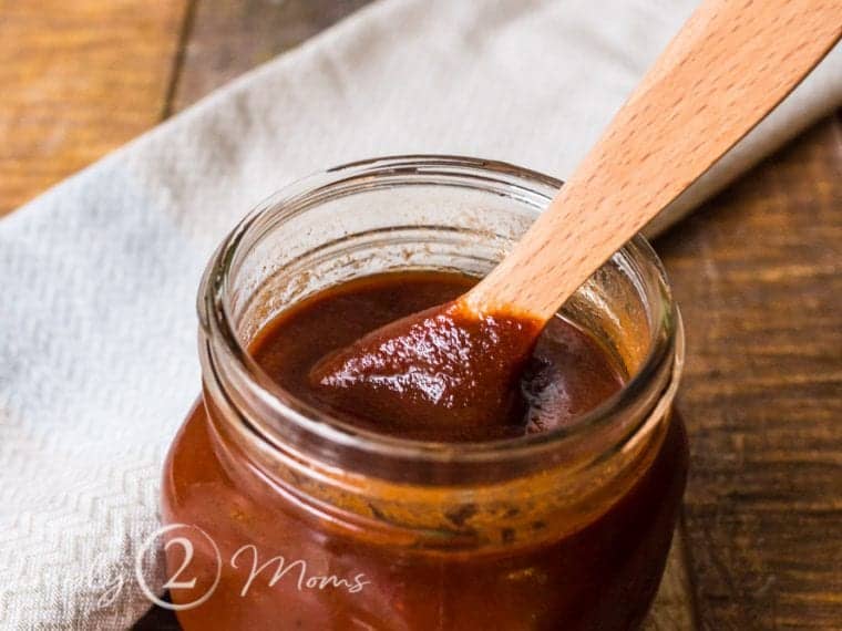 Sweet and Smoky Low Carb Barbecue sauce in a jar with a wooden spoon