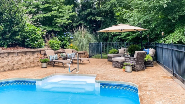 pool and patio surrounded by trees feature photo