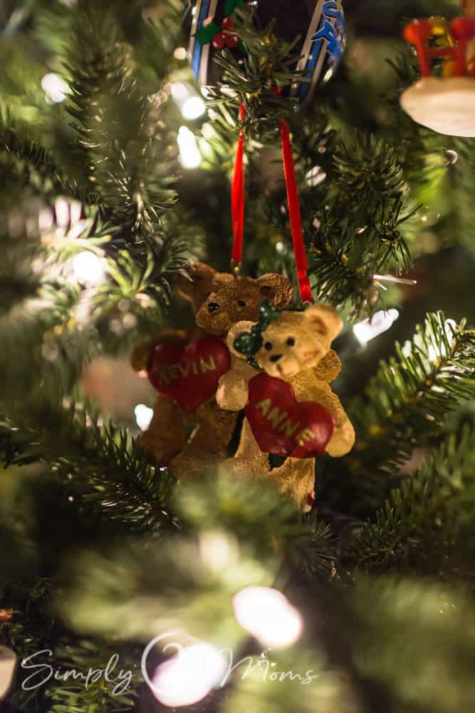 Christmas tree ornament with two teddy bears standing arm in arm holding hearts with names on them