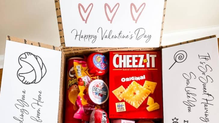 box filled with snacks and candy for Valentine's day care package