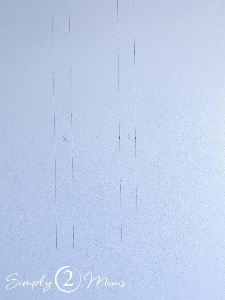 Wall with pencil markings for where to hang picture moulding