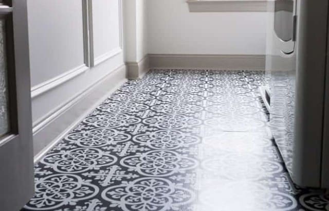 Finished laundry room floor with black and white wallpops peel and stick vinyl tile in Gothic pattern.