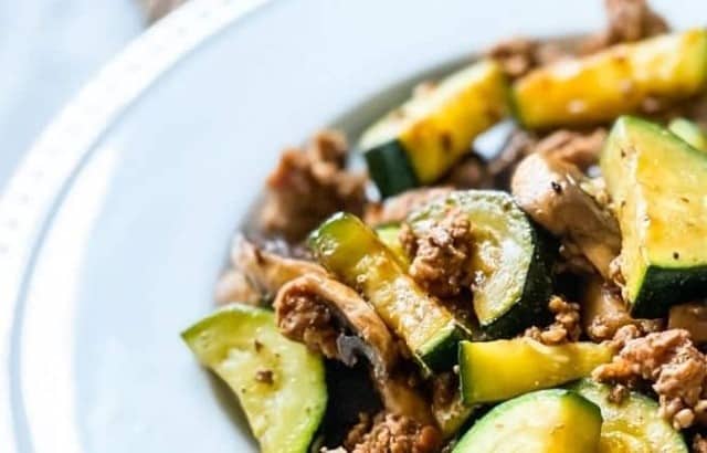 Half of a plate filled with ground beef and zucchini stirfry