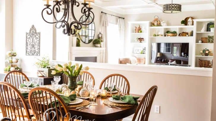 Cherry wood kitchen table with French country chandelier decorated for spring with natural elements