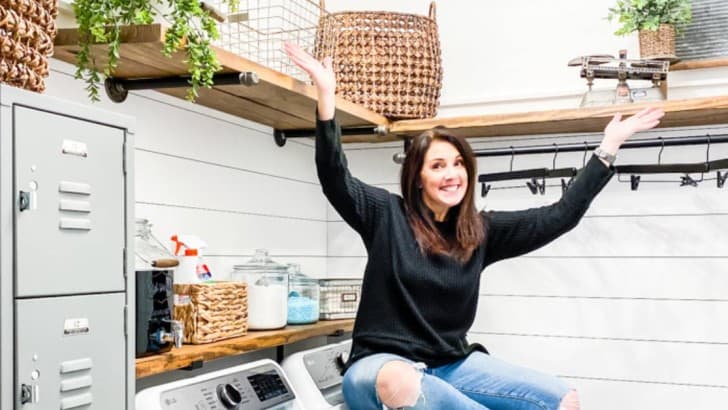 blogger sitting on dryer in laundry room