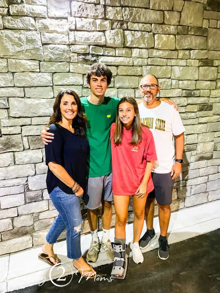 family outside college apartment building after moving student in