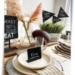 football tailgate party tablescape feature photo showing football themed centerpiece with chalkboard sign and flags in faux grasses and football