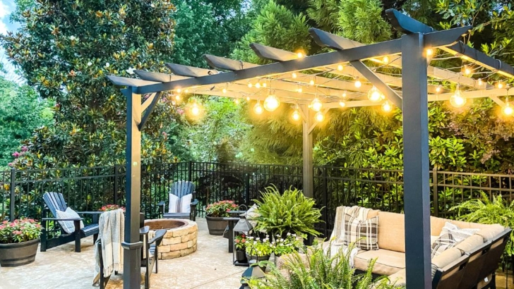 view of AQ lighting string lights hung from black metal pergola on patio