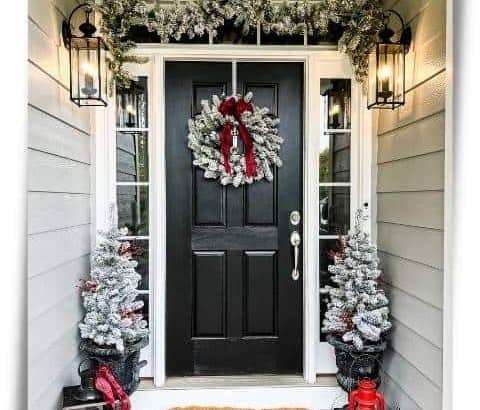 Black front door decorated for Christmas with King of Christmas 4-piece flocked set with red accents