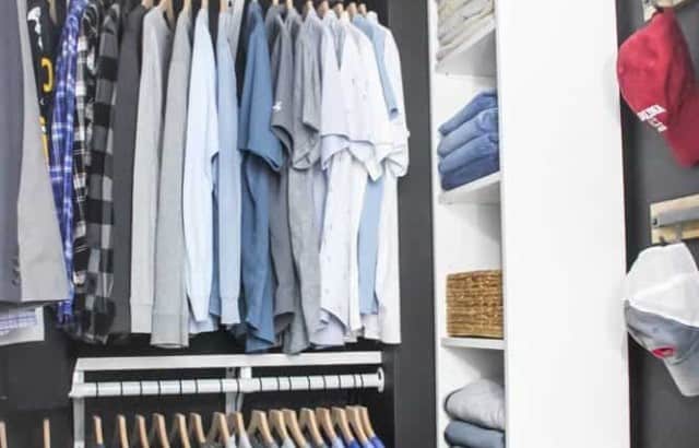 diy walk in closet makeover two hanging rods with clothes hanging on hangers on back wall and shelf unit with folded clothing storage on left baskets on top shelves of closets