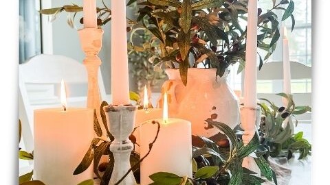 dining table centerpiece created with faux greenery olive stems and white candles