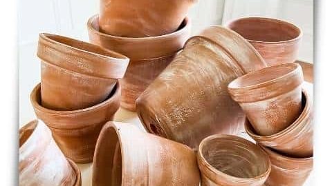 stacks of small faux aged pots on wood table