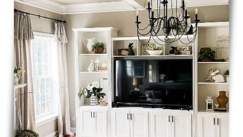 French country transitional family room painted Revere Pewter with white built-in entertainment center decorated for spring