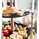 Black metal tiered tray filled with keto foods for an afternoon tea party