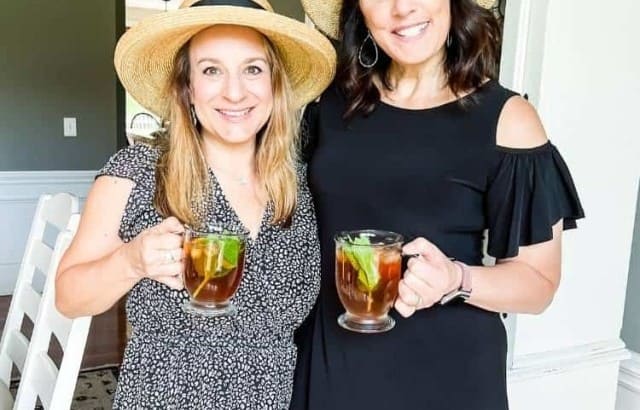 bloggers standing together holding adult tea beverage
