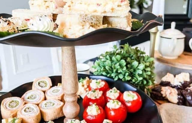 two tiered tray filled with tea party food
