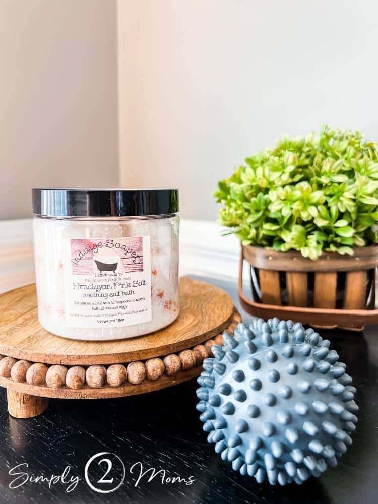 bath salt jar and spiky ball on wood pedestal