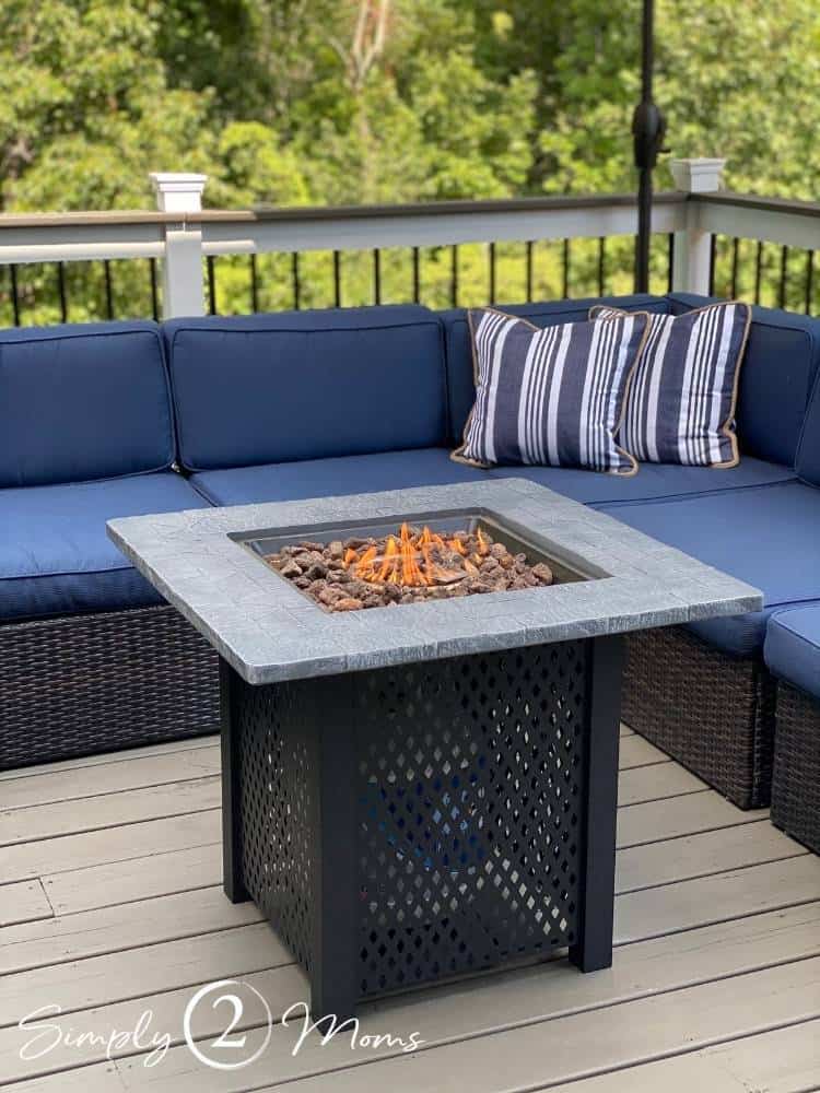 fire pit table on deck in front of outdoor sectional sofa