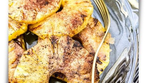 Platter of fresh grilled pineapple rings showing grill marks