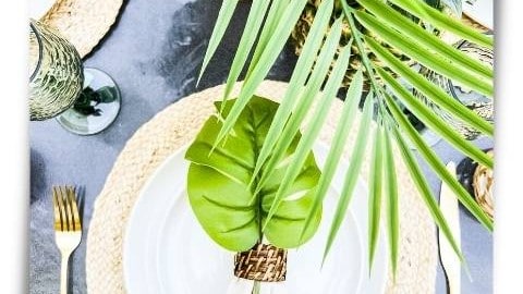 overhead view of place setting with luau greenery