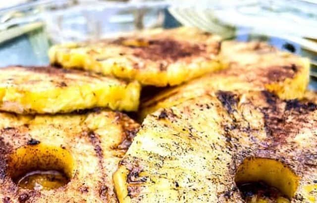 Platter of fresh grilled pineapple rings showing grill marks