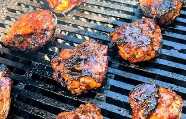 Huli Huli chicken thighs cooking on a grill