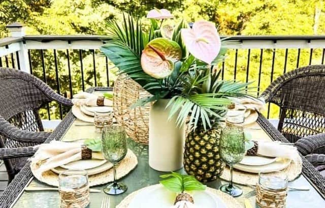 luau party tablescape for adults outside on deck with trees behind