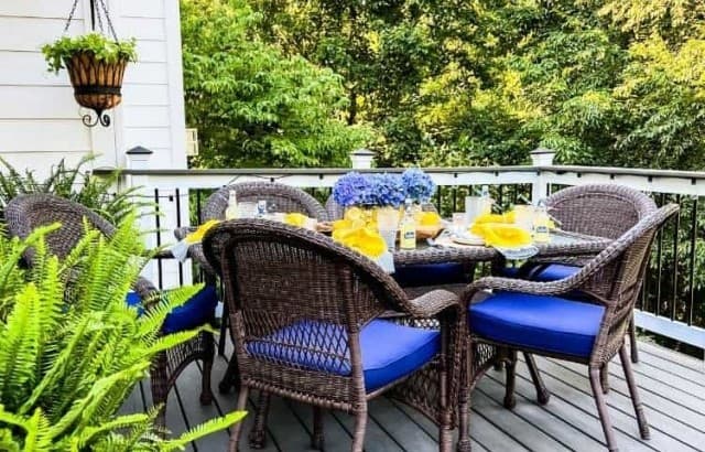 pulled back photo of outdoor dining table set in yellow and blue for BBQ party