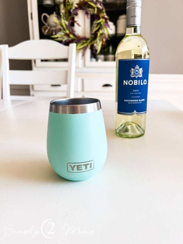 Yeti wine tumbler on table in front of bottle of wine