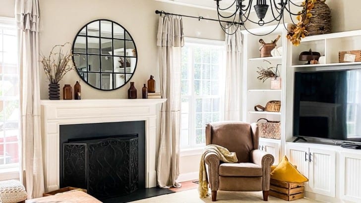 Family room with neutral colors decorated for fall with vintage and natural pieces.