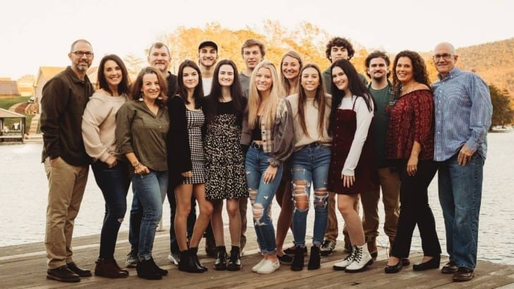 group of friends and families on dock by lake on Thanksgiving