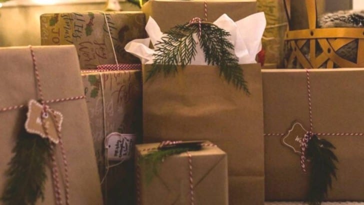 brown paper wrapped gifts with fresh greenery