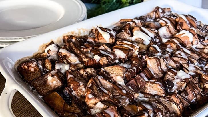 Keto chocolate chip French toast casserole drizzled with chocolate and glaze.