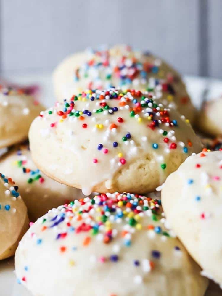cookies with white icing and rainbow sprinkles