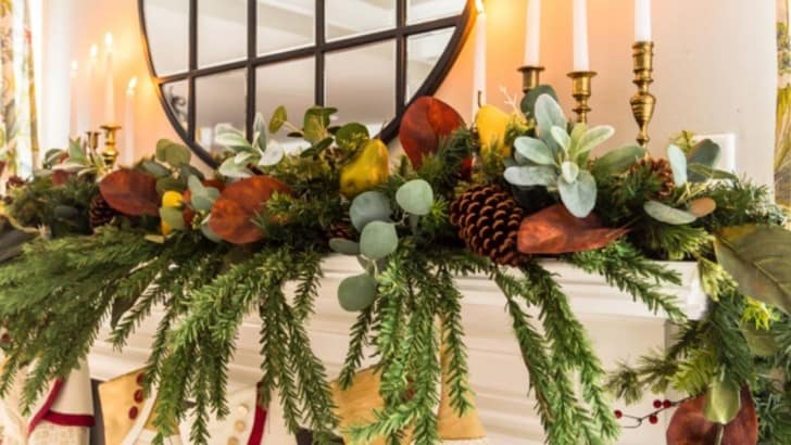 feature photo of fireplace mantel decorated with faux greenery stems and garland