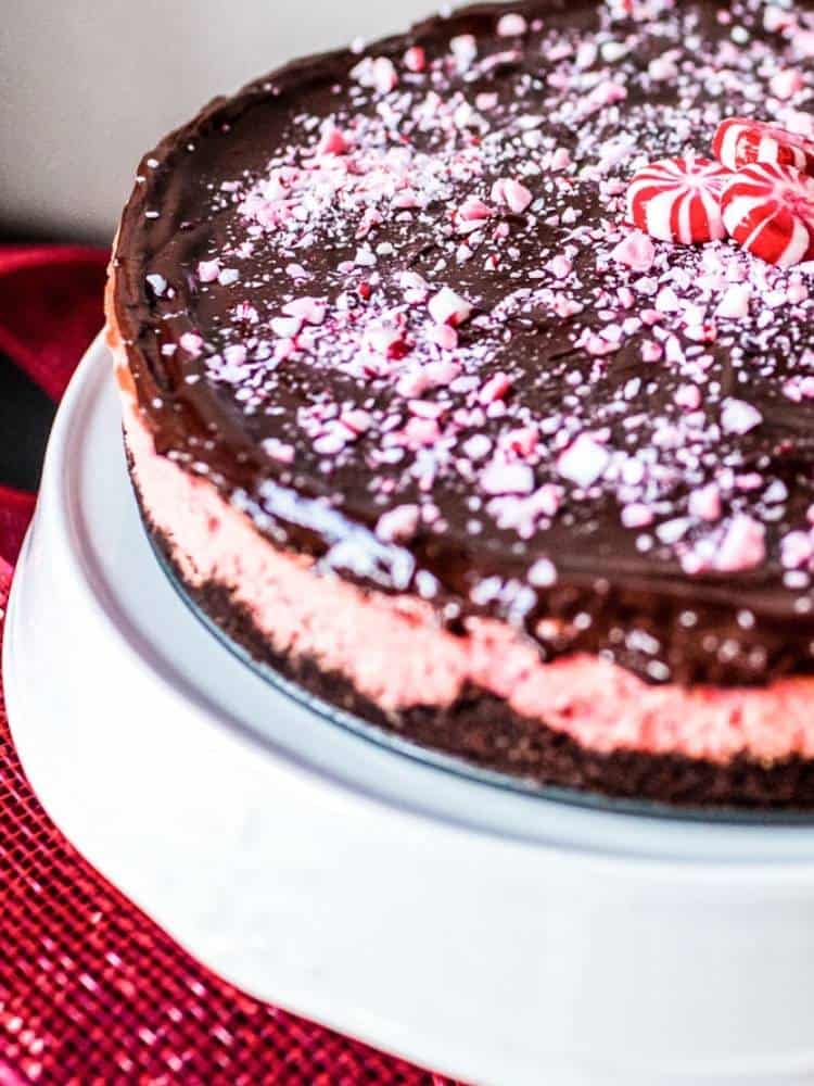 layered peppermint cheesecake on white cake stand