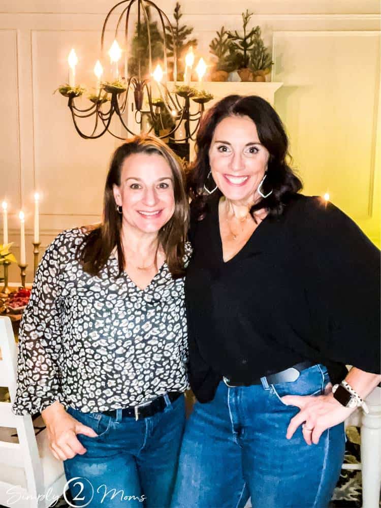 Bloggers standing beside dining table at wine and cheese party