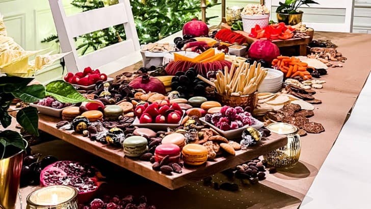 Dining table covered with brown paper and covered with charcuterie to create a grazing table.
