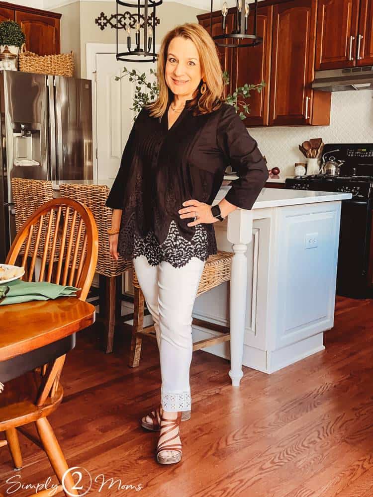 Anne wearing pants and top from Chicos standing in kitchen