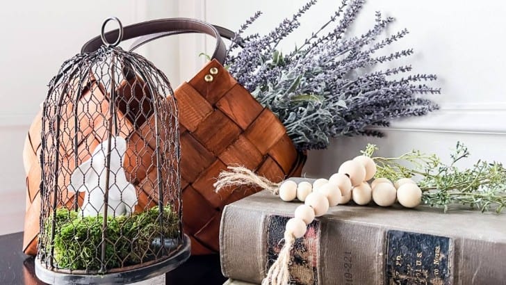 wood bead carrots on vintage books next to basket of lavender and bunny feature photo
