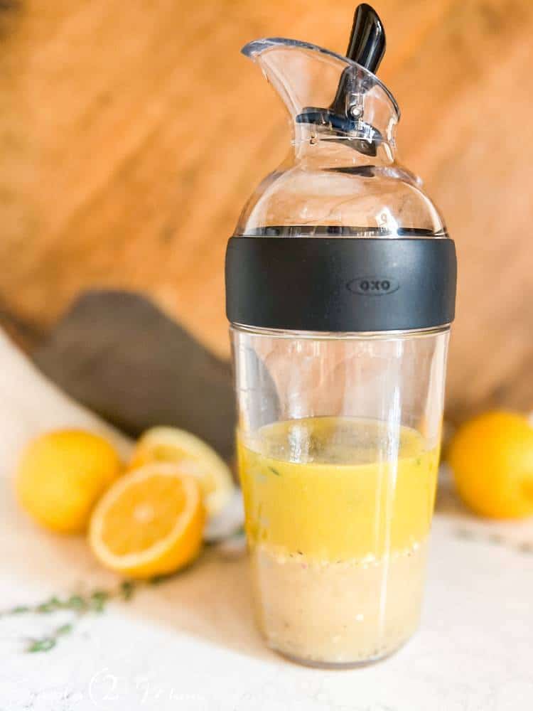 OXO salad dressing shaker bottle filled with sweet lemon salad dressing.