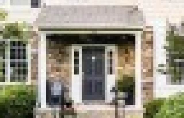 overgrown hedges in front of house before makeover