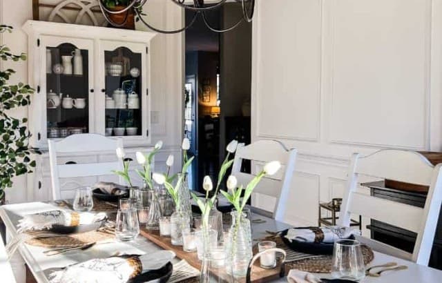 room decorated for spring with table settings and greenery