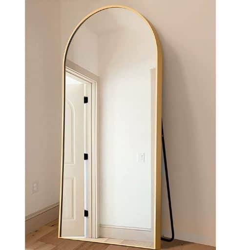 Full-length floor mirror with a gold frame that's arched at the top.